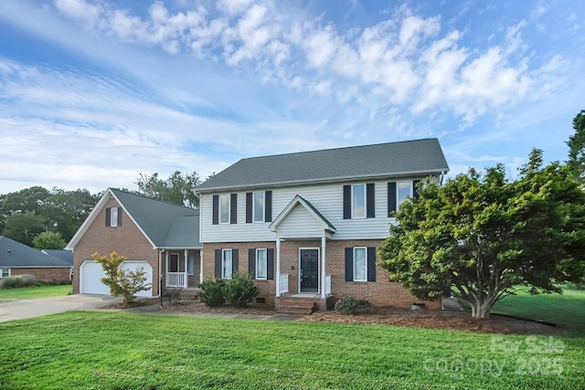 colonial house featuring a front lawn and a garage