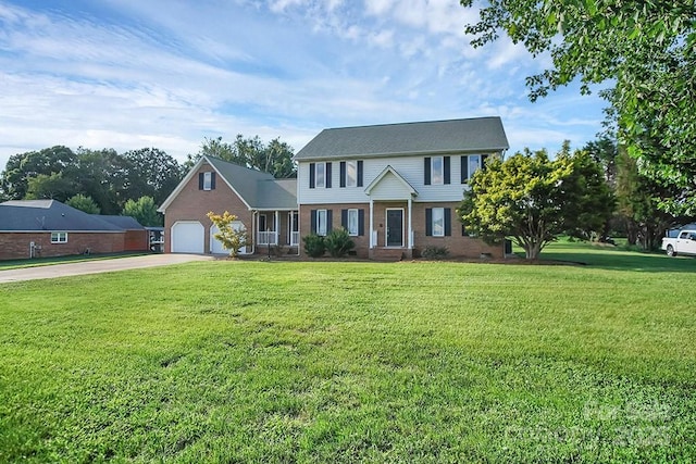 colonial-style house with driveway, a garage, a front yard, and brick siding