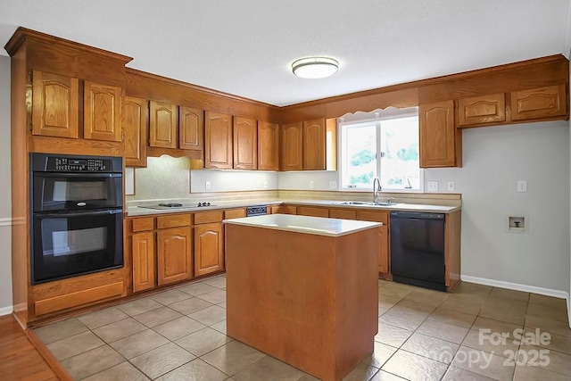 kitchen featuring brown cabinets, light countertops, black appliances, a sink, and light tile patterned flooring