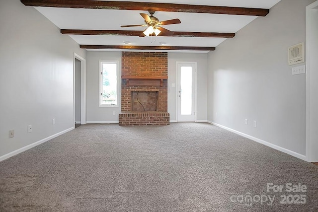 unfurnished living room featuring ceiling fan, carpet floors, a fireplace, baseboards, and beamed ceiling