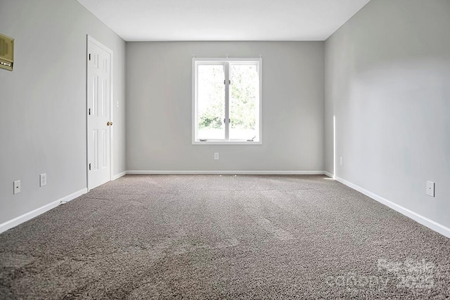 carpeted spare room with baseboards