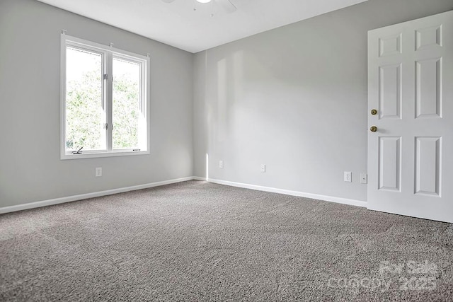 unfurnished room featuring ceiling fan, carpet flooring, and baseboards