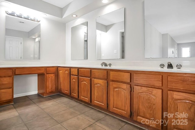 full bath featuring double vanity, a sink, and tile patterned floors