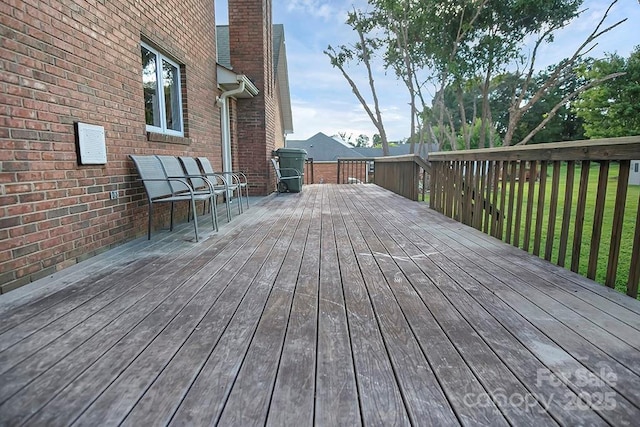 wooden terrace with a yard