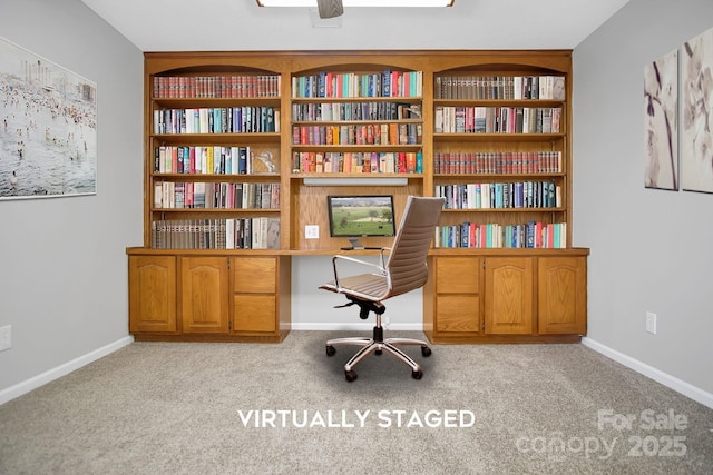 office featuring light colored carpet, baseboards, and built in study area