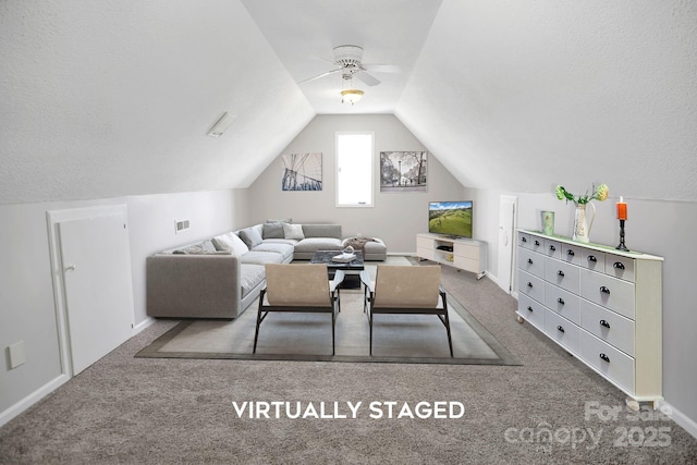 living area with carpet floors, lofted ceiling, a textured ceiling, and baseboards