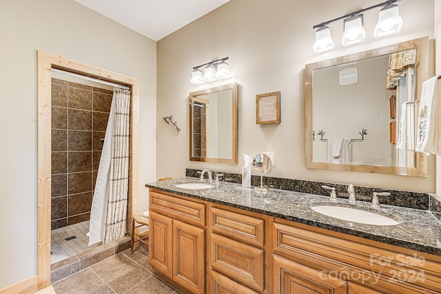 bathroom with tile patterned floors, walk in shower, and vanity