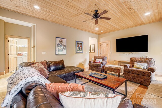 living room with ceiling fan, light hardwood / wood-style floors, and wooden ceiling