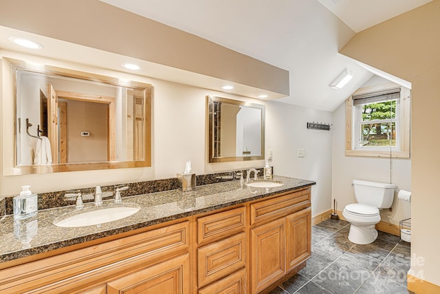 bathroom featuring lofted ceiling, tile patterned flooring, toilet, and vanity