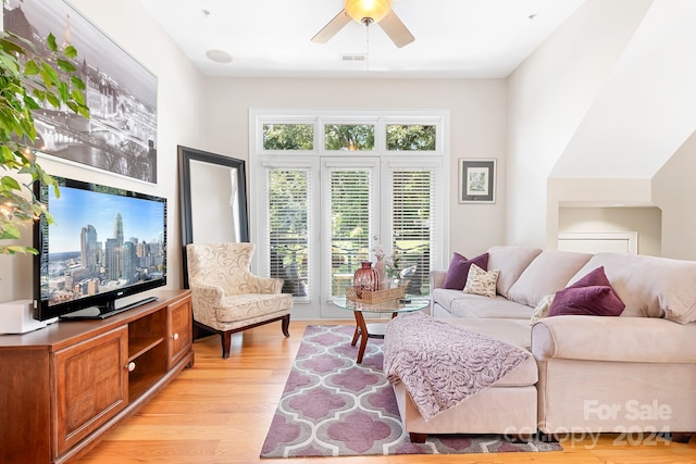 living room featuring ceiling fan, light hardwood / wood-style floors, and french doors