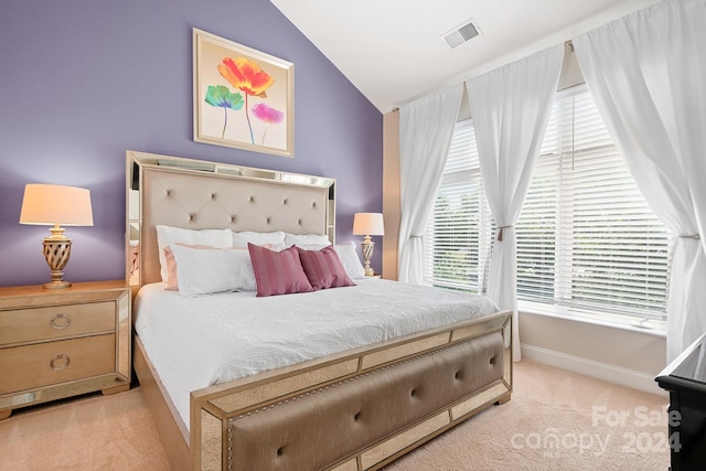 carpeted bedroom featuring lofted ceiling