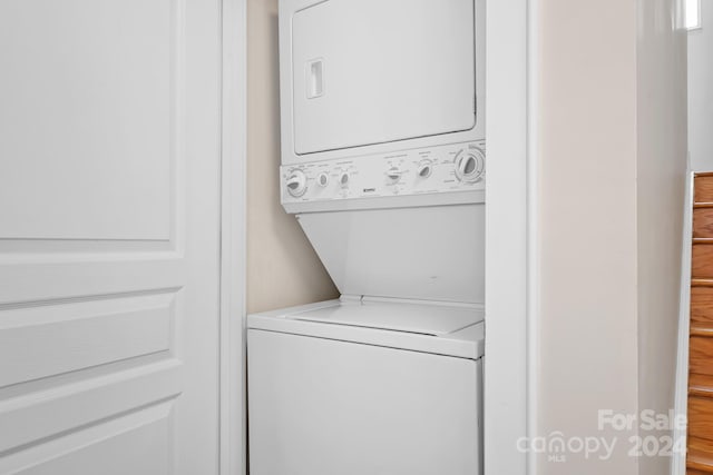 laundry room with stacked washer and clothes dryer