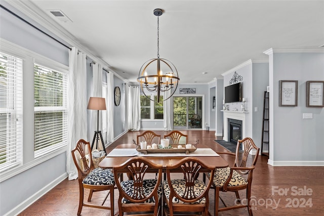 dining room with ornamental molding, dark hardwood / wood-style floors, and a healthy amount of sunlight