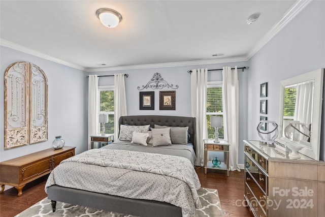 bedroom featuring multiple windows, dark wood-type flooring, and crown molding