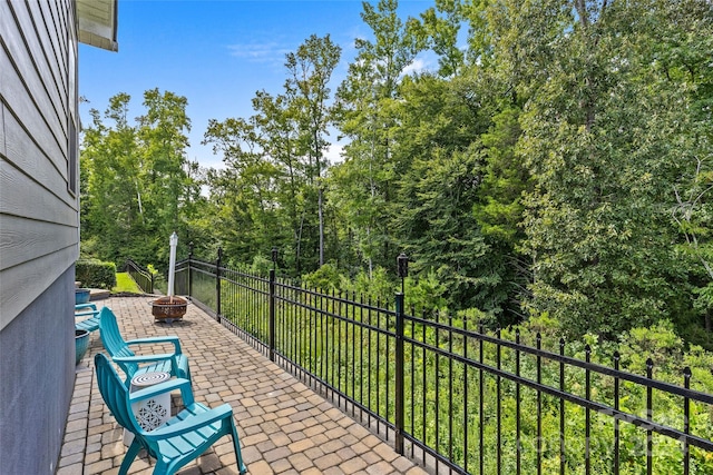 balcony featuring a patio and a fire pit