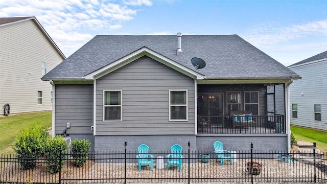 rear view of property with a patio area, a sunroom, and a pool