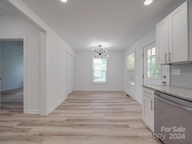 interior space with white cabinetry, stainless steel dishwasher, light hardwood / wood-style flooring, and a healthy amount of sunlight