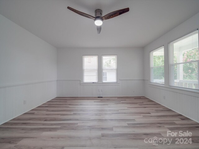 unfurnished room with ceiling fan and wood-type flooring