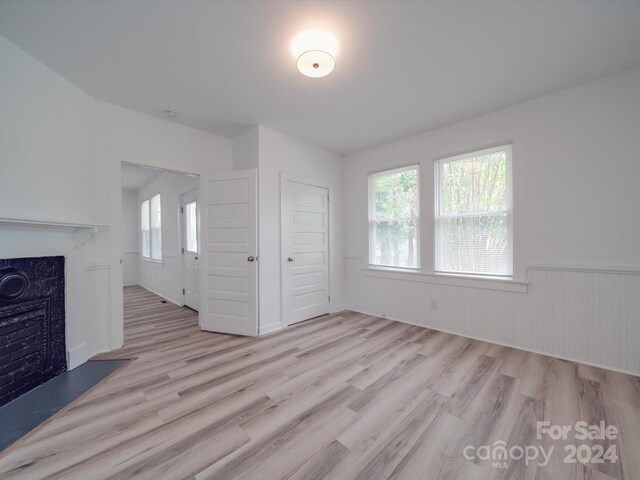 unfurnished living room featuring light hardwood / wood-style floors