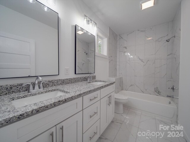 full bathroom featuring tiled shower / bath, toilet, tile patterned floors, and vanity