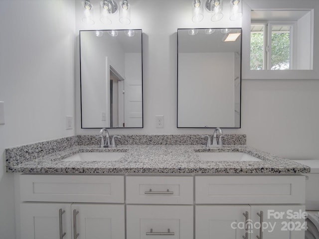 bathroom with double vanity and a sink