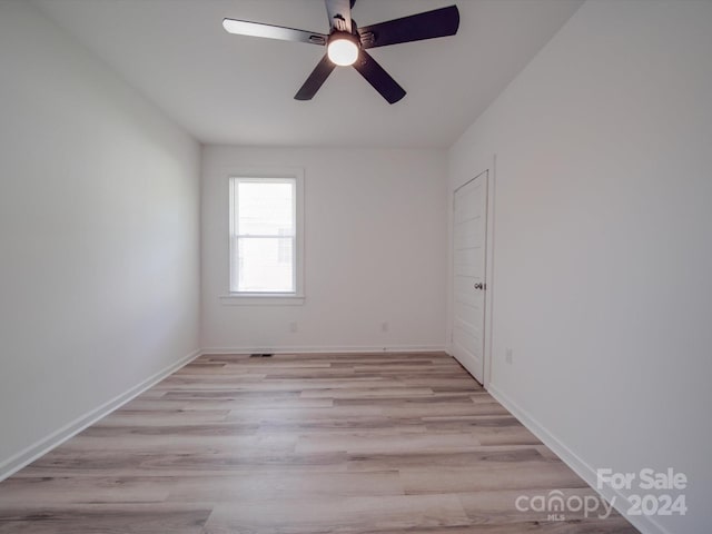 spare room with light wood-type flooring and ceiling fan