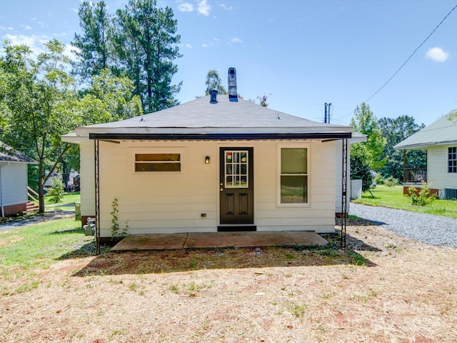 rear view of property with a lawn