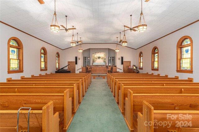 carpeted bedroom featuring lofted ceiling and ornamental molding