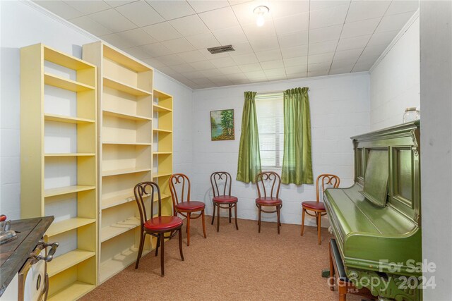 sitting room with carpet and crown molding