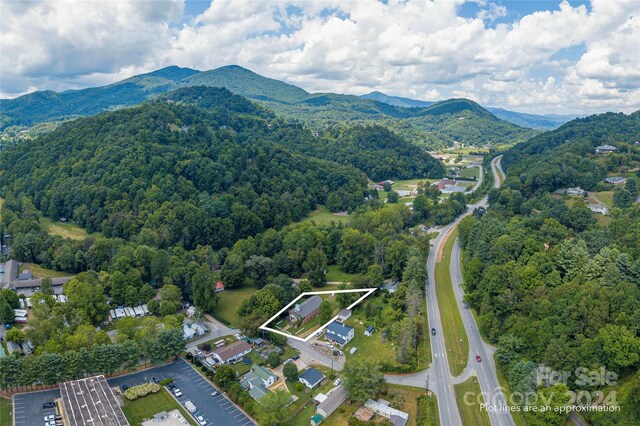 birds eye view of property with a mountain view