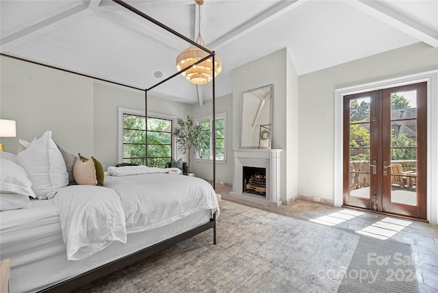 bedroom with lofted ceiling with beams, french doors, and access to outside