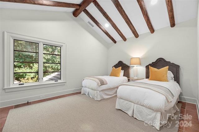 tiled bedroom with lofted ceiling with beams