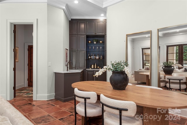 dining room with sink and ornamental molding