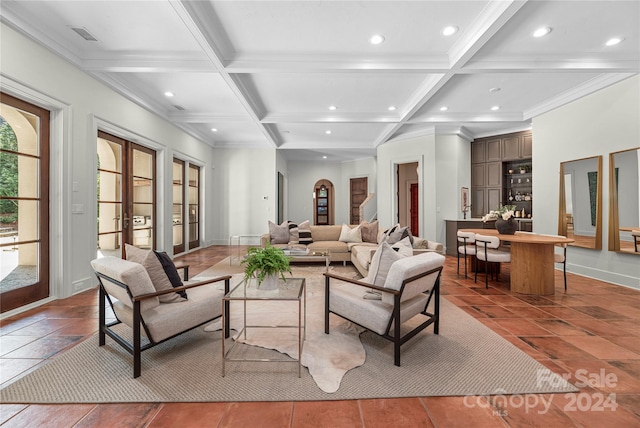 tiled living room featuring french doors, coffered ceiling, and beam ceiling