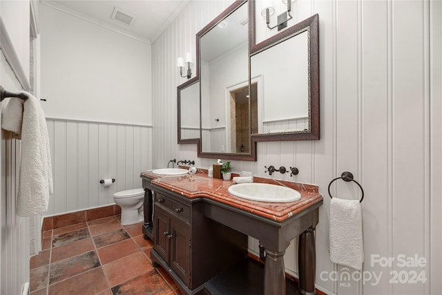 bathroom with toilet, crown molding, and vanity