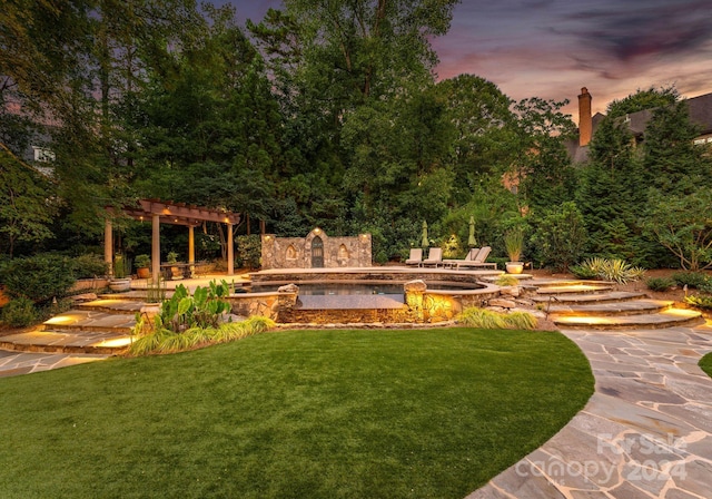 yard at dusk featuring a patio area and a pergola