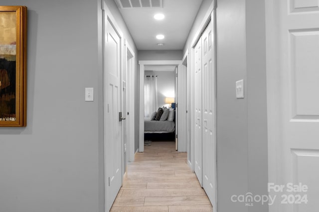 hall featuring recessed lighting, visible vents, and light wood-type flooring