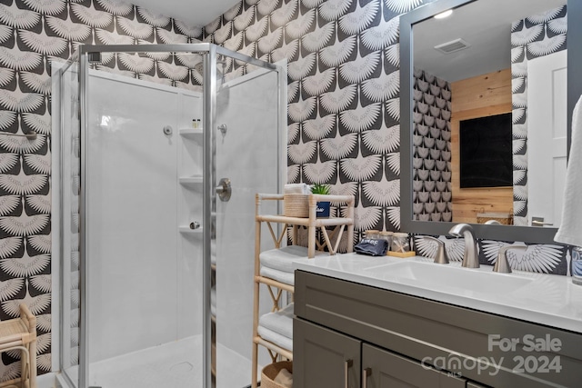 bathroom with visible vents, a stall shower, and vanity