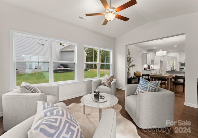 living room with lofted ceiling, dark wood-type flooring, visible vents, and baseboards