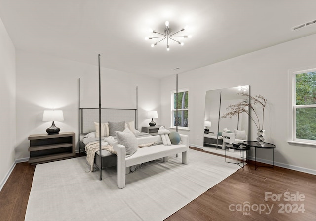 6034 Jepson Ct, Charlotte, NC 28214 - bedroom featuring visible vents, multiple windows, an inviting chandelier, and wood finished floors