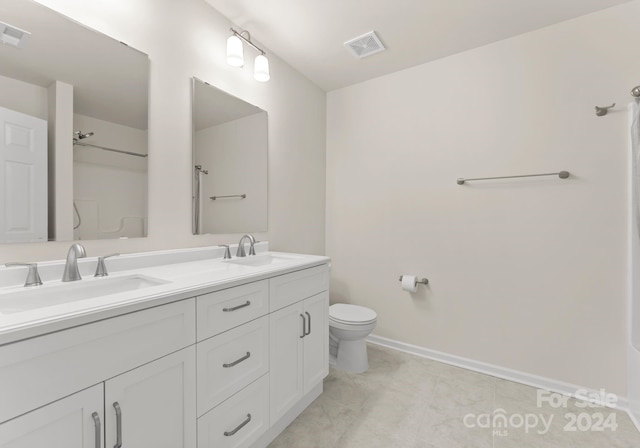 6034 Jepson Ct, Charlotte, NC 28214 - bathroom featuring double vanity, toilet, visible vents, and a sink