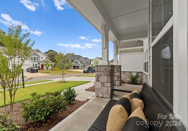 view of patio featuring a porch and a residential view