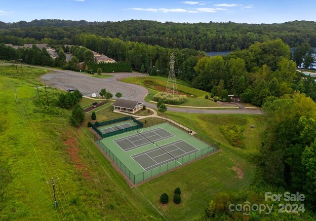 birds eye view of property featuring a wooded view