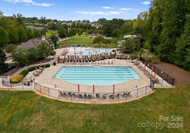 6034 Jepson Ct, Charlotte, NC 28214 - community pool with a lawn, a patio, and fence