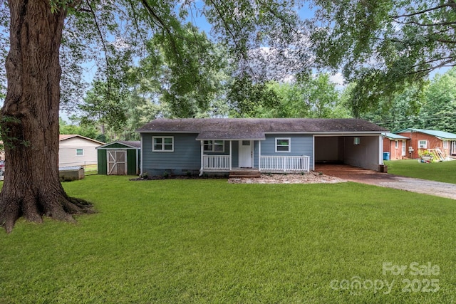 single story home featuring a front lawn, a carport, a porch, and a storage shed