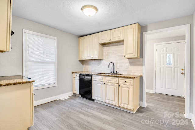 kitchen with light hardwood / wood-style flooring, backsplash, sink, a textured ceiling, and black dishwasher