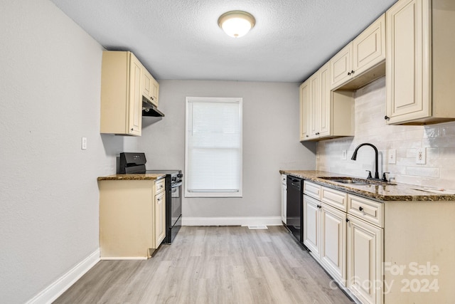 kitchen with dark stone counters, light hardwood / wood-style floors, sink, black dishwasher, and range with electric stovetop