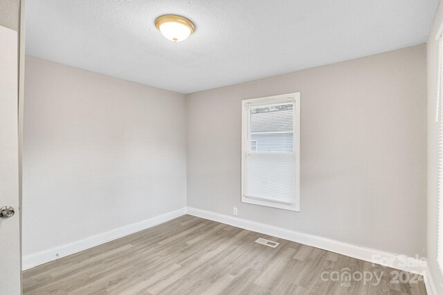 unfurnished room featuring hardwood / wood-style flooring