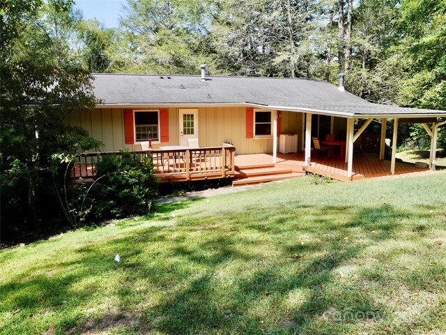 back of property featuring a yard and a deck