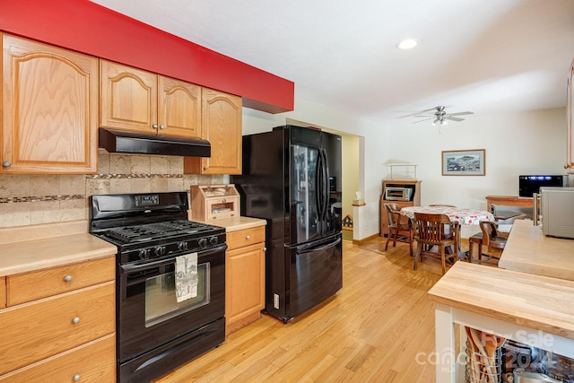 19 Brookcliff Dr, Asheville, NC 28804 - kitchen with ceiling fan, under cabinet range hood, light wood-type flooring, decorative backsplash, and black appliances